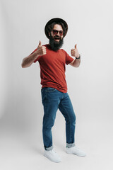 A casual bearded man in a red shirt and blue jeans giving a double thumbs up. Positive vibes and...
