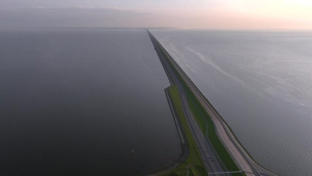 Long Road in the Sea. Afsluitdijk construction on pumping stations, new sluices and A7 Highway in Northern Netherlands. 