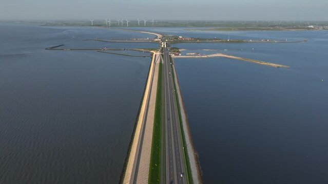Afsluitdijk construction on pumping stations, new sluices and A7 Highway in Northern Netherlands. Long Road in the Sea.