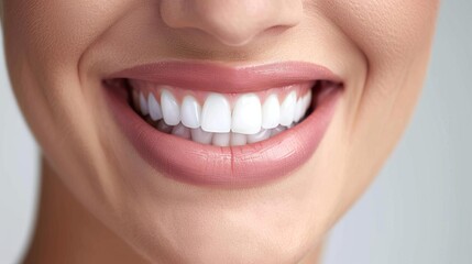 Obraz premium A closeup of a womans smiling mouth with bright teeth,