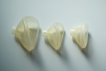 On the table there are face masks for anesthesia machines of different sizes. Horizontal shot.