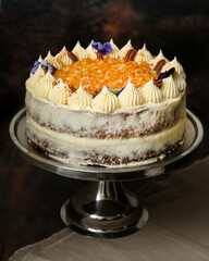 Damascus and pecan cake beautifully decorated on a dark brown background. Naked Cake.