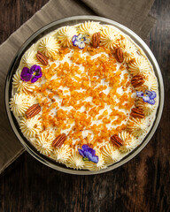 Damascus and pecan cake beautifully decorated on a dark brown background. Naked Cake.