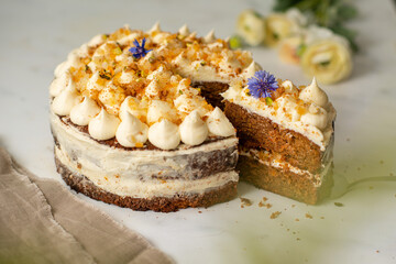Vegan raw carrot cake on a white table. Healthy food. 