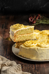 Lemon cake decorated with cream on top, on a rustic wooden table. Sponde cake  