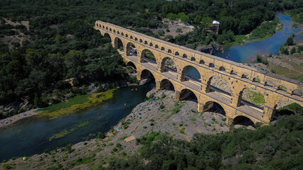 Fototapeta premium Aerial view of Pont du Gard, and ancient aqueduct Roman bridge infrastructure in the South of France.