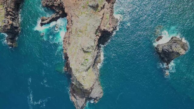 Aerial drone view of Farol da Ponta de S&atilde;o Louren&ccedil;o, capturing the stunning coastal scenery and rugged cliffs of Madeira, Portugal.