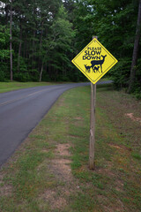 Traffic sign warning about herd of deer crossing the road. Vertical image.