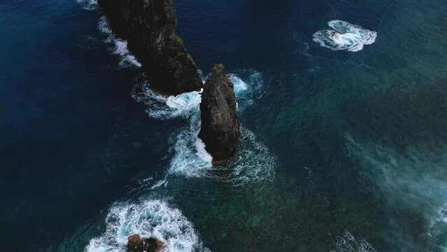 Aerial view of Miradouro Ilh&eacute;us da Ribeira da Janela, showcasing the dramatic rock formations and stunning coastal landscape of Madeira, Portugal.