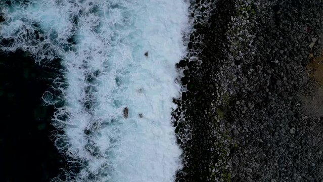 Aerial view of Miradouro Ilh&eacute;us da Ribeira da Janela, showcasing the dramatic rock formations and stunning coastal landscape of Madeira, Portugal.