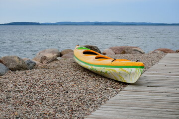 A close up on a kayak or a boat made out of glass fiber or other buoyant material standing next to...