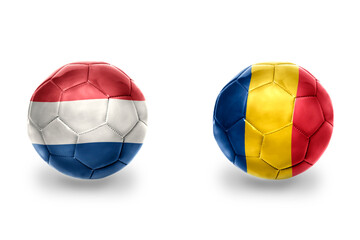 football balls with national flags of romania and netherlands ,soccer teams. on the white background.