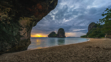 sunset at the princess cave beach on railay beach in thailand