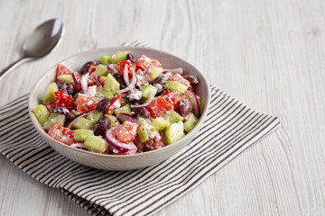 Homemade Chopped Mediterranean Salad in a Bowl, side view. Copy space.