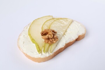 Delicious bruschetta with ricotta cheese, pears and walnut on white background