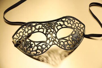 Elegant face mask on beige background. Theatrical performance