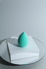 Stylish presentation of makeup sponge on light grey background