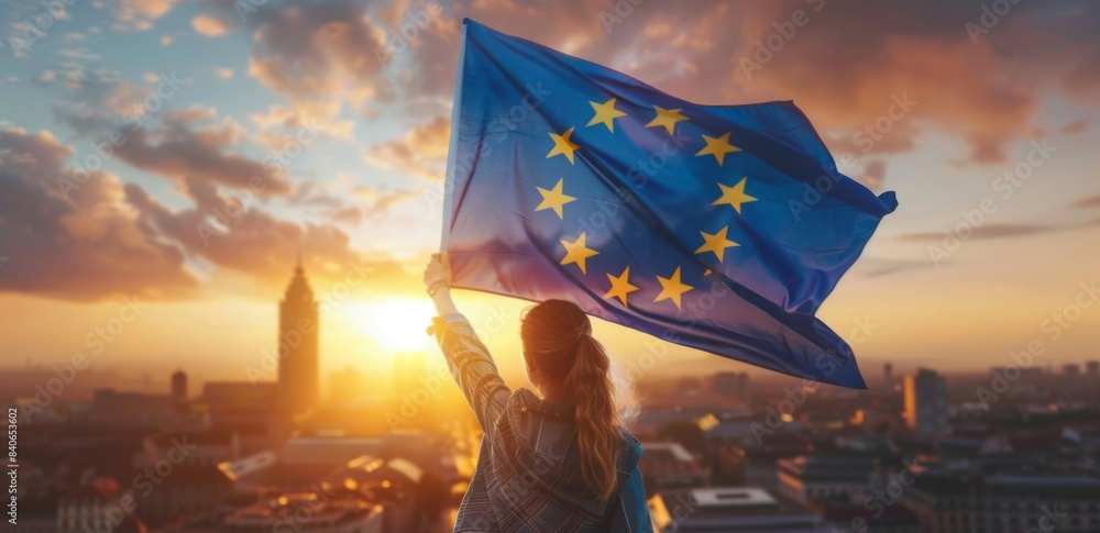 Wall mural young woman holds european flag in her hands