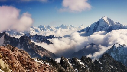 Obraz premium Stunning visual of rugged mountains with snow caps peaking through the soft clouds, conveying a sense of tranquility and power