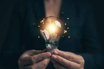 Bright light bulb in hand, idea search concept, creativity
