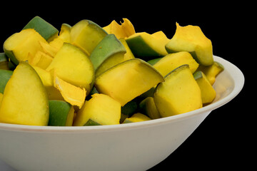 Side View Of Slices of Mango for Mango Pickle In White Bowl, Isolated On Black Background