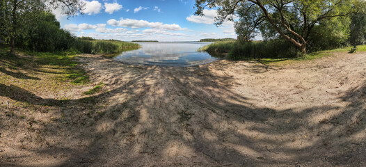 Panorama view from above of the summer landscape. Orange sunset sky, fields and forests, rivers and roads
