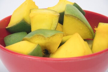 Side View Of Slices of Mango for Mango Pickle In Red Bowl