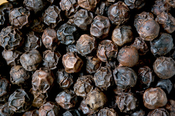 A close-up view of a heap of black pepper.