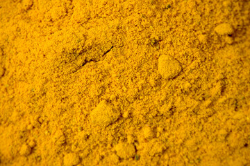 Aerial view of a pile of turmeric powder with a detailed close-up.