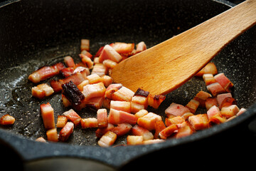 Sliced bacon on frying pan