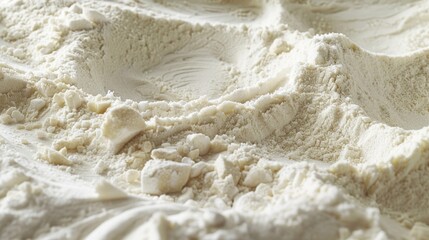 A textured image of flour shows a mixture of large and small grains creating a heterogeneous feel