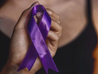 A woman holds a purple ribbon in her hand