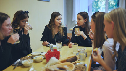 High school students eat in the cafeteria.