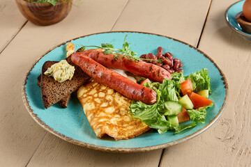 Healthy Breakfast Plate with Omelet, Sausages, Beans, Toast, and Mixed Salad on Rustic Table