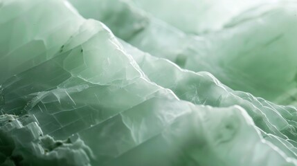 The surface of a smooth jade gemstone appears almost luminescent reflecting a pale green light that masks any visible texture