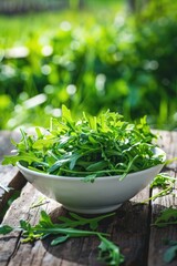 arugula in a white bowl on a wooden table. Selective focus