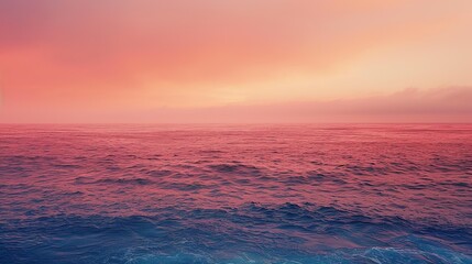 Obraz premium An abstract of a coral-colored sunset over the ocean, with the sky and water blending into a beautiful hue.