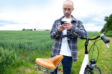 young man cyclist's tranquil journey through verdant fields harmonious blend of eco-conscious...