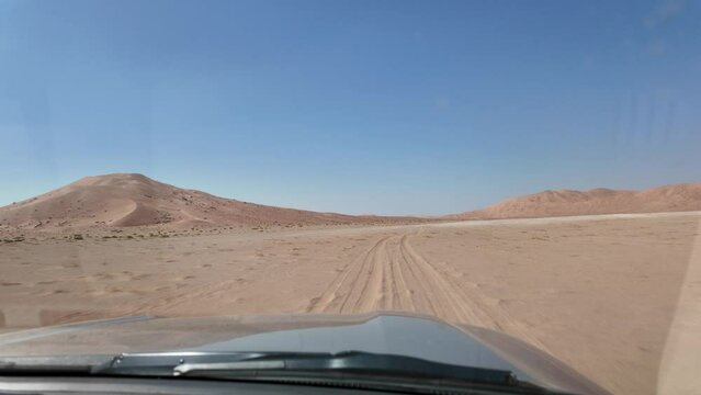 In POV, first person view of desert safari races through Oman's Empty Quarter Rub' al Khali desert. Dune bashing in the thrilling expanse, an adrenaline-fueled ride in the Middle East.