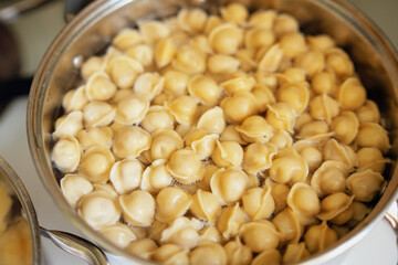 Small dumplings simmering in a pot, epitomizing home-cooked comfort food
