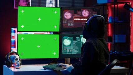 Fototapeta premium Happy man writing code on green screen PC, celebrating after managing to get past security systems. Joyous hacker feeling proud after breaching firewall using mockup computer, camera A