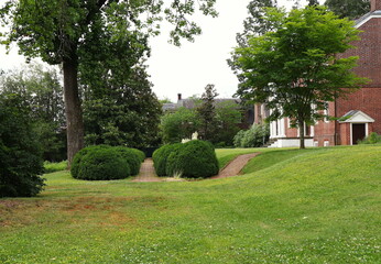 Elegant Landscaping with Sloping Lawn and Trimmed Shrubbery