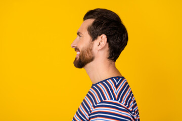 Side profile photo of cheerful guy with stylish stubble wear striped t-shirt look at sale empty...