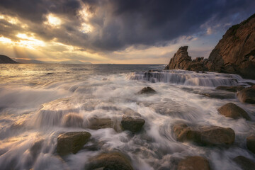 Sunset with dramatic sky on Azkorri beach, Getxo
