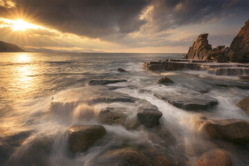 Sunset with dramatic sky on Azkorri beach, Getxo