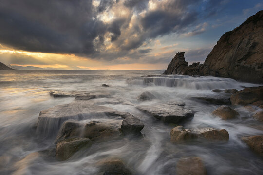 Sunset with dramatic sky on Azkorri beach, Getxo