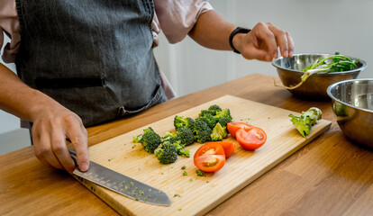 Chef at the kitchen preparing tofu scramble with vegetables