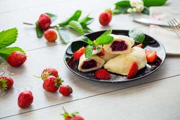 cooked sweet homemade steamed dumplings with strawberries