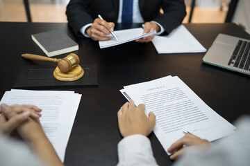 Legal counsel presents to the client a signed contract with gavel and legal law. justice and lawyer concept