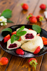 cooked sweet homemade steamed dumplings with strawberries